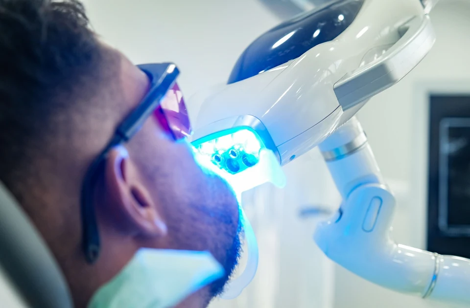 Adult undergoing a professional teeth whitening treatment at the dentist