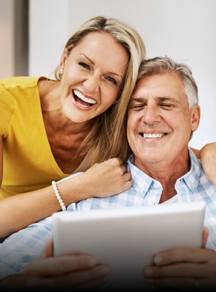 Couple smiling together after a smile transformation