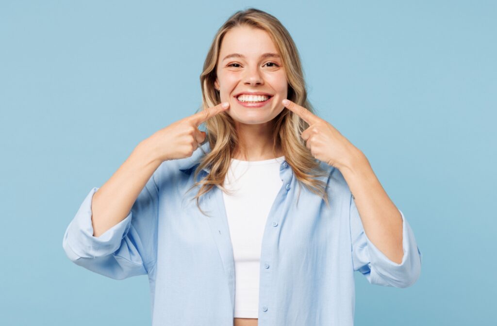 A happy patient showing off their bright, beautiful, and confident smile from dental veneers.